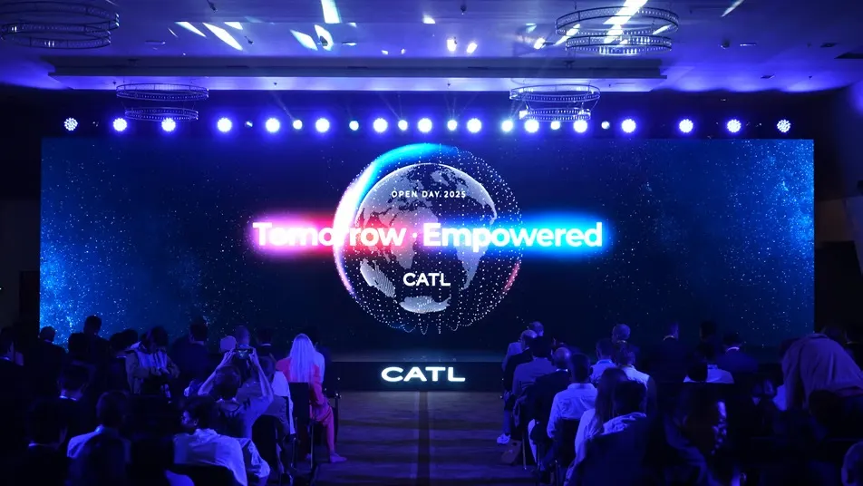 Audience facing a blue-lit CATL presentation stage in Munich.