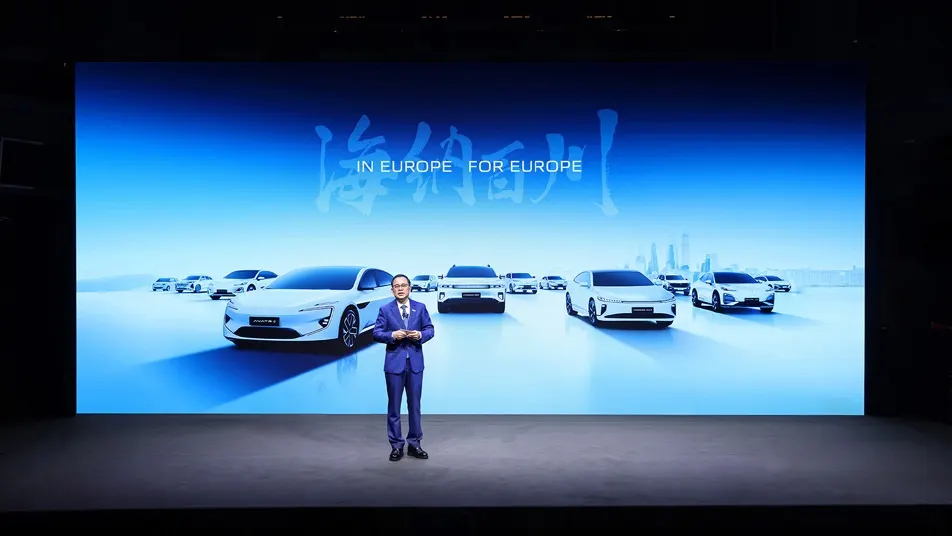 Presenter introducing Changan vehicles on a blue-lit Munich stage.