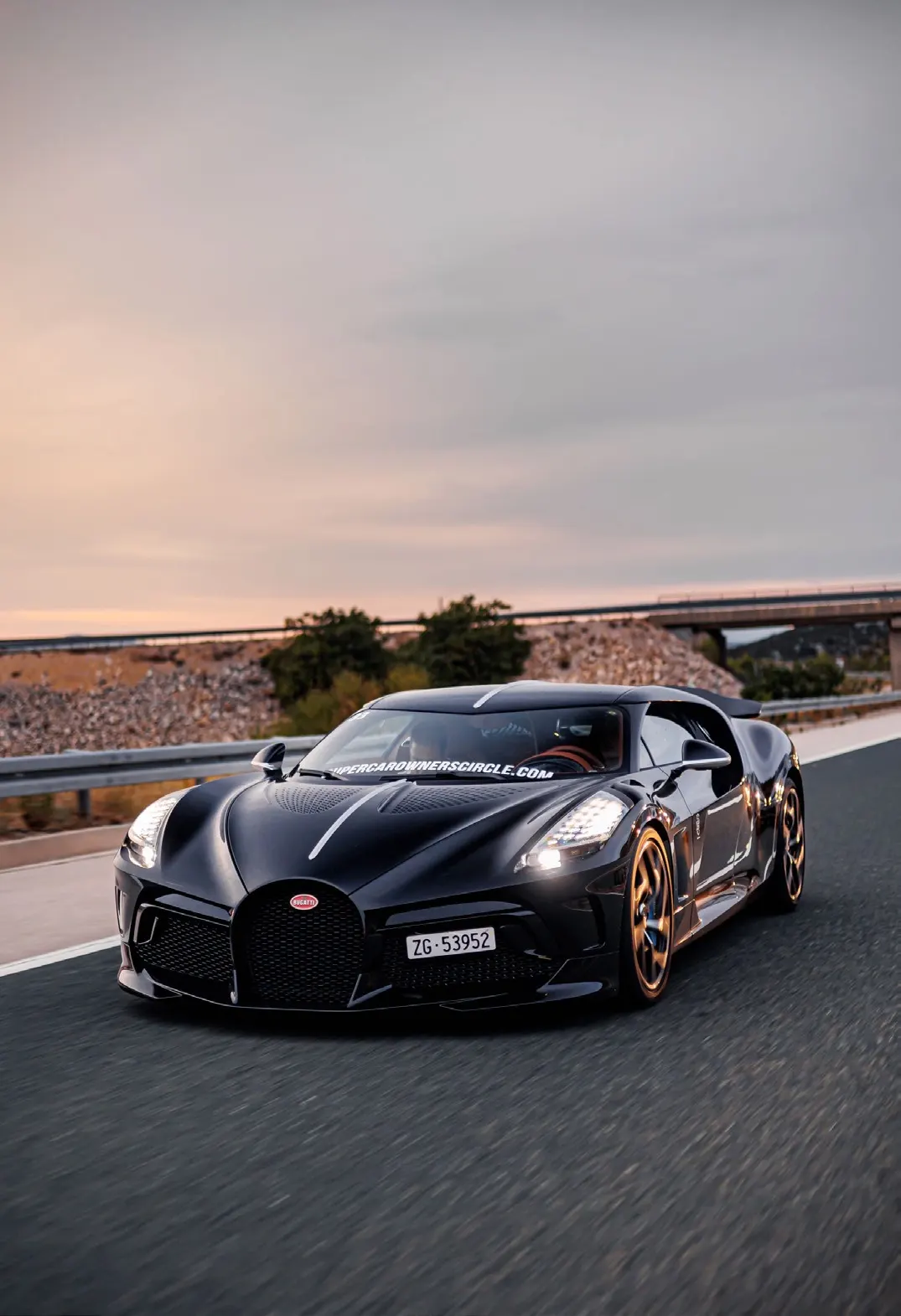 Low front tracking view of a performance car on a highway.