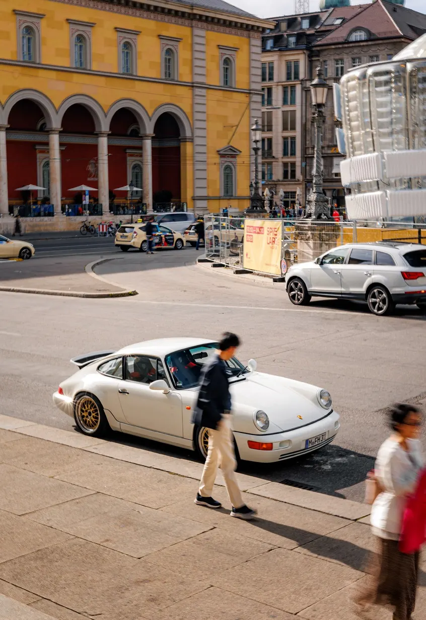 Sports cars travelling together on a European road.