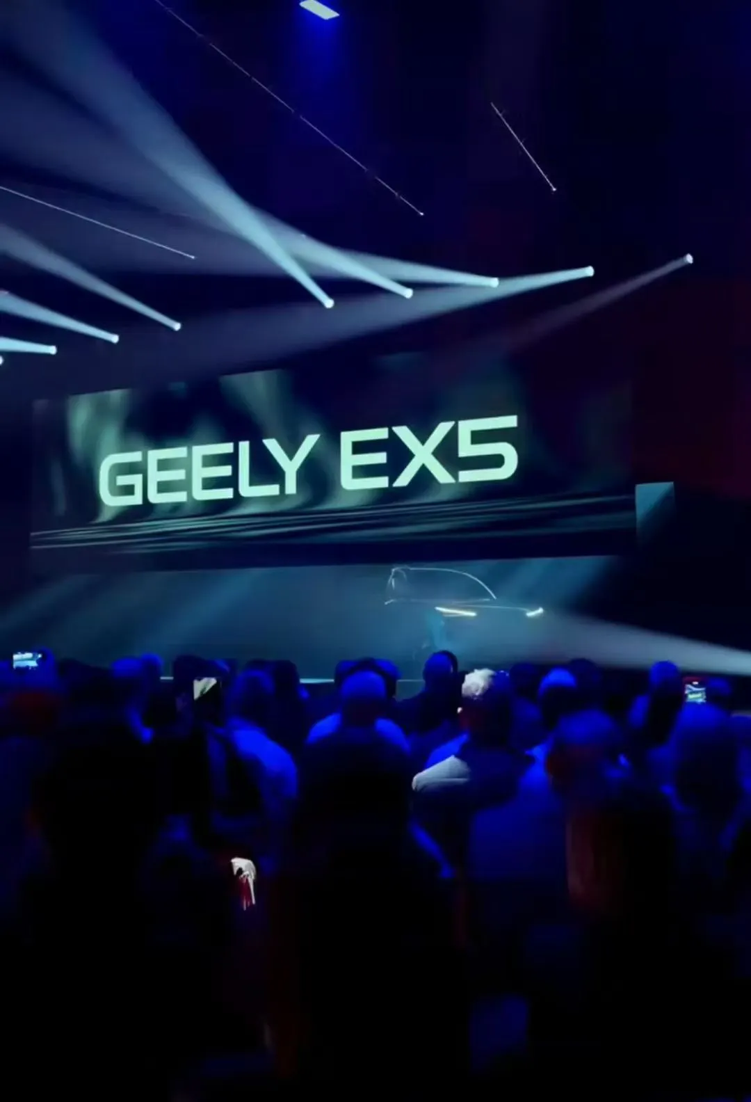 Geely EX5 presentation screen and guests at the London launch.