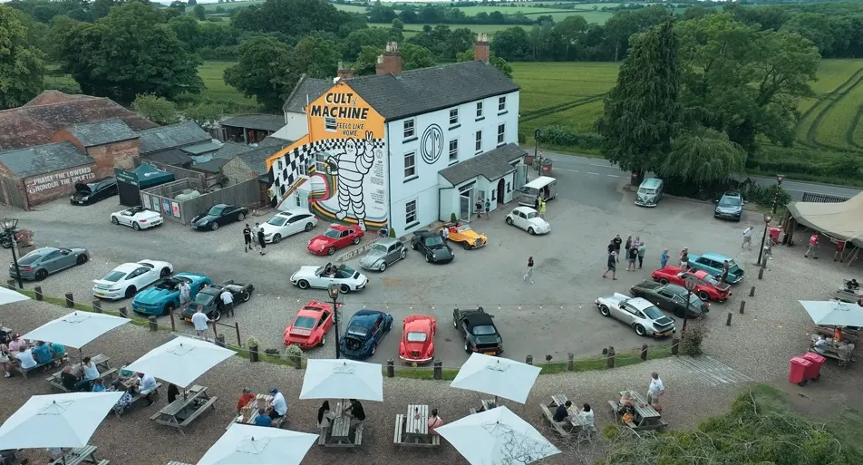 Aerial view of an automotive gathering in the English countryside.