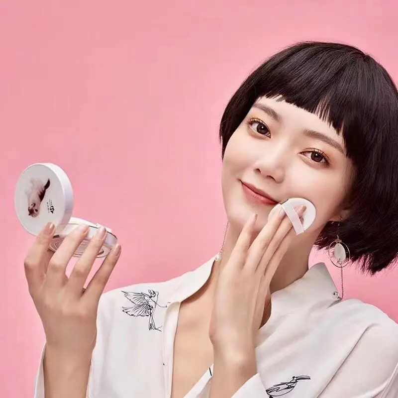 Beauty device product image with a model on a pink set.