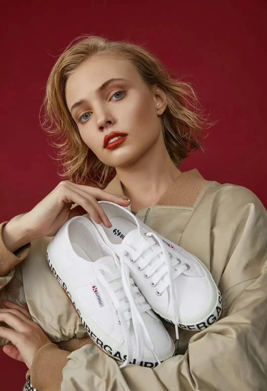 Footwear product editorial photographed against a blue background.