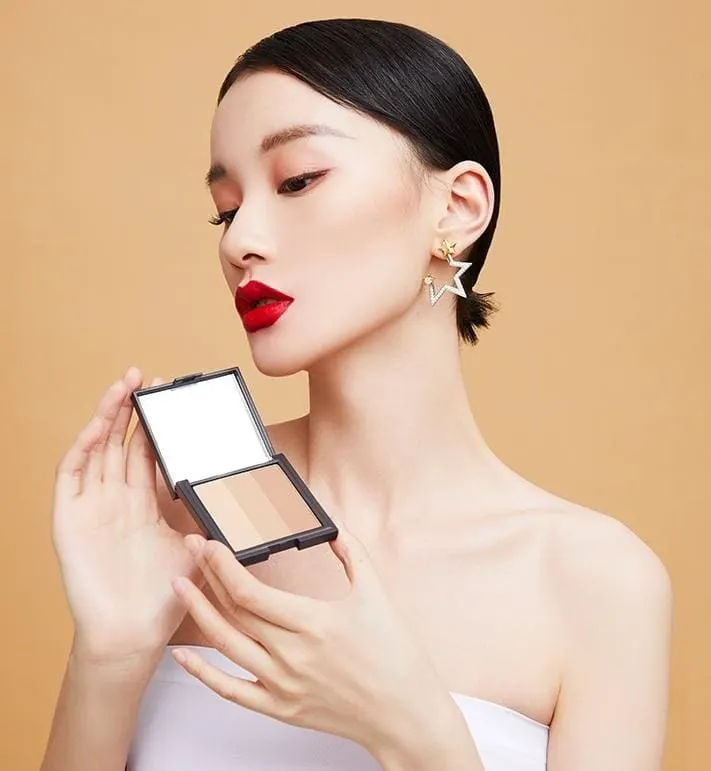 Makeup editorial portrait featuring a compact product.